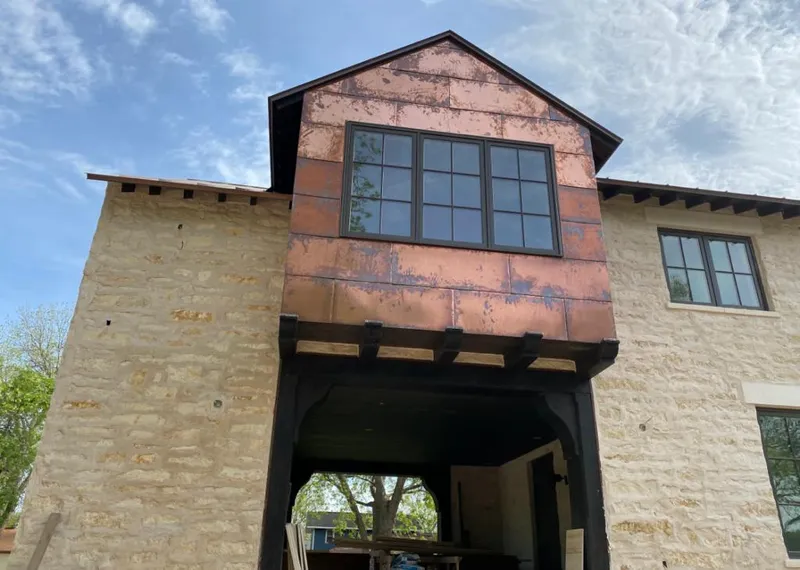 Copper metal panel facade on a stone building for Skylight Installation in Dowagiac